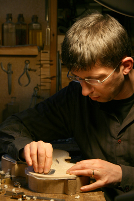 Andreas Hudelmayer working carefully on the front of an instrument